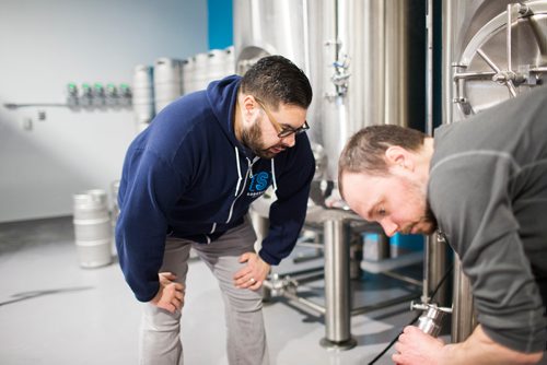 MIKAELA MACKENZIE / WINNIPEG FREE PRESS
Andrew Sookram, who's opening a new brewery called Sookram's, chats with Dan Simpson in the brewing area in Winnipeg on Wednesday, March 6, 2019. 
Winnipeg Free Press 2019.