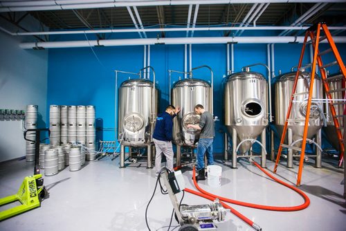 MIKAELA MACKENZIE / WINNIPEG FREE PRESS
Andrew Sookram, who's opening a new brewery called Sookram's, chats with Dan Simpson in the brewing area in Winnipeg on Wednesday, March 6, 2019. 
Winnipeg Free Press 2019.