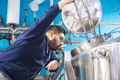 MIKAELA MACKENZIE / WINNIPEG FREE PRESS
Andrew Sookram, who's opening a new brewery called Sookram's, takes a look in the mash tun in Winnipeg on Wednesday, March 6, 2019. 
Winnipeg Free Press 2019.