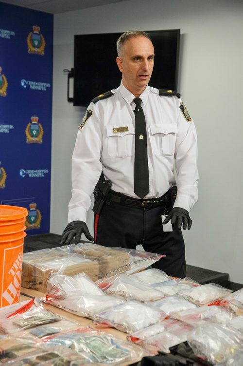 MIKE DEAL / WINNIPEG FREE PRESS
Winnipeg Police Max Waddell Inspector in charge of organized crime division shows off drugs (2 kilograms of cocaine), $215,000 in cash, and a .45 cal handgun as well as other drug dealing material that was seized recently during a couple of raids in the Bridgwater Forest and Garden City neighbourhoods.
190306 - Wednesday, March 06, 2019.