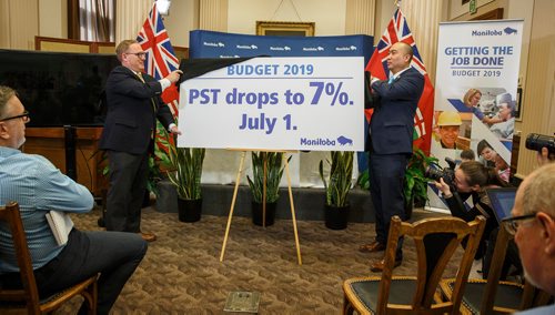 MIKE DEAL / WINNIPEG FREE PRESS
Minister of Finance Scott Fielding (left) and MLA John Reyes reveal the intention of the government to reduce the PST to 7% on July 1st during the Media Lockup for the 2019 Provincial Budget prior to the tabling of the budget in the Manitoba Legislative Chamber Thursday.
190307 - Thursday, March 07, 2019.