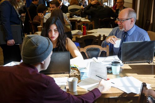 MIKE DEAL / WINNIPEG FREE PRESS
Winnipeg Free Press reporters (from left) Ryan Thorpe, Jessica Botelho-Urbanski, and Larry Kusch, read and discuss the 2019 Provincial Budget documents during the Media Lockup prior to the tabling of the budget in the Manitoba Legislative Chamber Thursday.
190307 - Thursday, March 07, 2019.