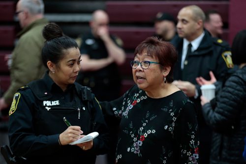 PHIL HOSSACK / WINNIPEG FREE PRESS -Perla Javate chats with a city police officer at a community meeting / Police Forum at Daniel McIntyre Collegiate Thursday evening. See Alex Paul story.  - March7, 2019