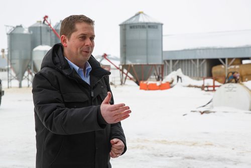 MIKE DEAL / WINNIPEG FREE PRESS
Federal Conservative Party Leader, Andrew Scheer with Gordon Grenkow on his family farm near Winnipeg, MB, speaks to the media regarding his plan to remove the GST from home heating and energy bills if his party is elected.
190308 - Friday, March 08, 2019.