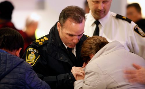 PHIL HOSSACK / WINNIPEG FREE PRESS - City Police Chief Danny Smyth consoles Imelda Adao, in a crowd  a crowd gathered at the Maples Collegiate re: community fear around recent home invasion, murder and meth. Her son was murdered in a recent home invasion. See Story.March 8, 2019.