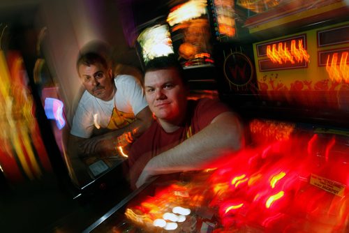 PHIL HOSSACK / WINNIPEG FREE PRESS - David Morris (right) and Mark Jaslowski pose in their Pinball Popup Friday night at the Forks See Declan's story re:Pinball Popup. January 8, 2019.