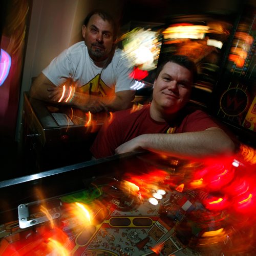 PHIL HOSSACK / WINNIPEG FREE PRESS - David Morris (right) and Mark Jaslowski pose in their Pinball Popup Friday night at the Forks See Declan's story re:Pinball Popup. January 8, 2019.