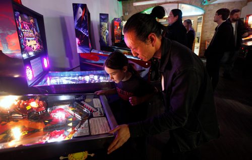 PHIL HOSSACK / WINNIPEG FREE PRESS - Cliff Lee and Nolan Swanson-Bilyk (12) enjoy a game of pinball Friday night at the Forks See Declan's story re:Pinball Popup. January 8, 2019.
