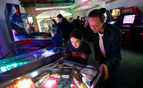 PHIL HOSSACK / WINNIPEG FREE PRESS - Cliff Lee and Nolan Swanson-Bilyk (12) enjoy a game of pinball Friday night at the Forks See Declan's story re:Pinball Popup. January 8, 2019.