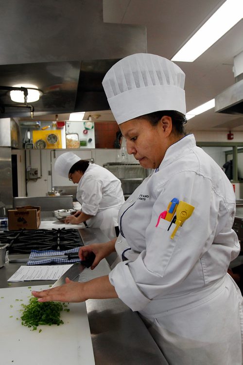 PHIL HOSSACK / WINNIPEG FREE PRESS - RRCC Culinary Skills Indigenous student Larissa Evans chops green onions for omelettes Alexa Raven slices mushrooms behind her for an Indigenous Pop Up restaurant. See Anders' story. -  March 11, 2019.