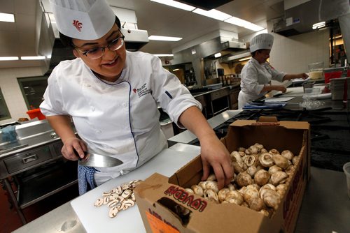 PHIL HOSSACK / WINNIPEG FREE PRESS - RRCC Culinary Skills Indigenous student Alexa Raven reaches for a mushroom to slice while Larissa Evans chops green onions for omelettes for an Indigenous Pop Up restaurant. See Anders' story. -  March 11, 2019.