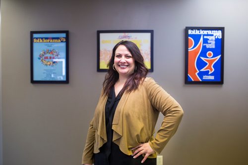 MIKAELA MACKENZIE / WINNIPEG FREE PRESS
Folklorama executive director Teresa Cotroneo poses for a portrait by some posters from the early years of the festival at the Folklorama offices in Winnipeg on Monday, March 11, 2019. 
Winnipeg Free Press 2019.