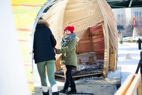 MIKAELA MACKENZIE / WINNIPEG FREE PRESS
Payton Farthing, eight (right), and Olivia Malloy, 11, spin around a sail at the warming huts, which are all gathered together on the river trail, at the Forks in Winnipeg on Monday, March 11, 2019. 
Winnipeg Free Press 2019.