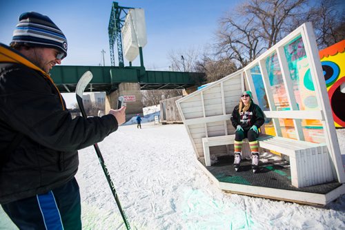 MIKAELA MACKENZIE / WINNIPEG FREE PRESS
Kyle Breckman takes a photo of his girlfriend, Madison Danyluk, at the warming huts, which are all gathered together on the river trail, at the Forks in Winnipeg on Monday, March 11, 2019. 
Winnipeg Free Press 2019.