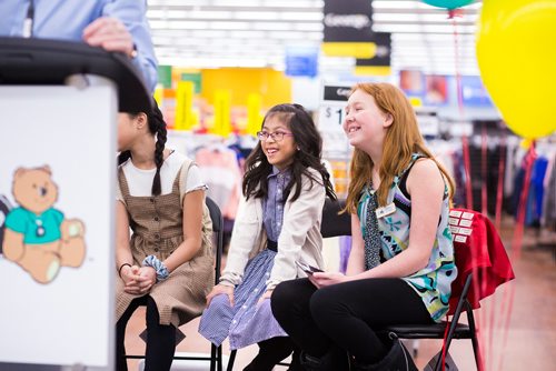 MIKAELA MACKENZIE / WINNIPEG FREE PRESS
Gianna Eusebio,  2019 Champion Child (centre), and Abigail Stewart, 2018 Champion Child (right), giggle while listening to speakers at the Walmart Winnipeg South Super Centre in Winnipeg on Tuesday, March 12, 2019. 
Winnipeg Free Press 2019.