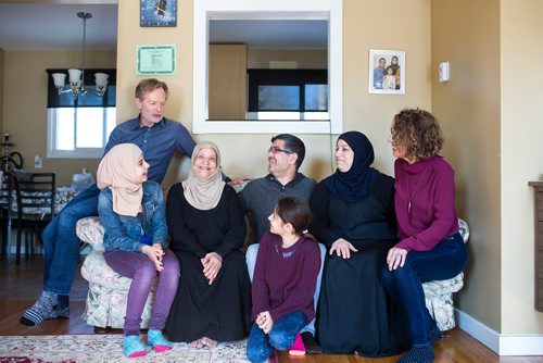 MIKAELA MACKENZIE / WINNIPEG FREE PRESS
Rolf Langelotz (top), Shahed Humsi (centre left to right), Mourina Homsi, Yasser Humsi, Badyra Humsi, Alana Langelotz, and Ghena Humsi (bottom) pose for a portrait at the Humsi family home in Winnipeg on Tuesday, March 12, 2019. The two families met through a Volunteer Matching Program with the Manitoba Interfaith Immigration Council that pairs Canadians up with newcomers.
Winnipeg Free Press 2019.