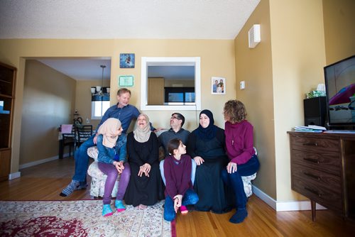MIKAELA MACKENZIE / WINNIPEG FREE PRESS
Rolf Langelotz (top), Shahed Humsi (centre left to right), Mourina Homsi, Yasser Humsi, Badyra Humsi, Alana Langelotz, and Ghena Humsi (bottom) pose for a portrait at the Humsi family home in Winnipeg on Tuesday, March 12, 2019. The two families met through a Volunteer Matching Program with the Manitoba Interfaith Immigration Council that pairs Canadians up with newcomers.
Winnipeg Free Press 2019.