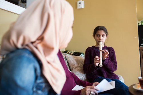 MIKAELA MACKENZIE / WINNIPEG FREE PRESS
Ghena Humsi, nine, plays her recorder for friends and family at the Humsi family home in Winnipeg on Tuesday, March 12, 2019. The two families met through a Volunteer Matching Program with the Manitoba Interfaith Immigration Council that pairs Canadians up with newcomers.
Winnipeg Free Press 2019.