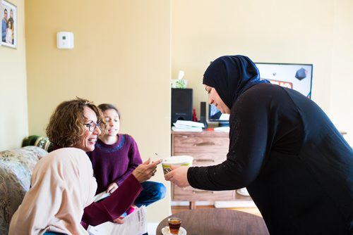 MIKAELA MACKENZIE / WINNIPEG FREE PRESS
Badyra Humsi gives her Canadian friends a taste of her homemade delicacies at the Humsi family home in Winnipeg on Tuesday, March 12, 2019. The two families met through a Volunteer Matching Program with the Manitoba Interfaith Immigration Council that pairs Canadians up with newcomers.
Winnipeg Free Press 2019.