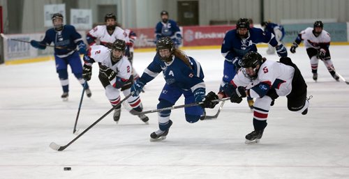 PHIL HOSSACK / WINNIPEG FREE PRESS -  Selkirk Royals #14 Cienna Palmer pushes past St Mary's Acadamy #2 Clare Hibbert and #5 Nicole Howarth in a late  last period effort. St Mary's Academy kept the lead and the WWHSHL championship Wednesday evening at the IcePlex.  See Taylor Allen story.- March13, 2019.