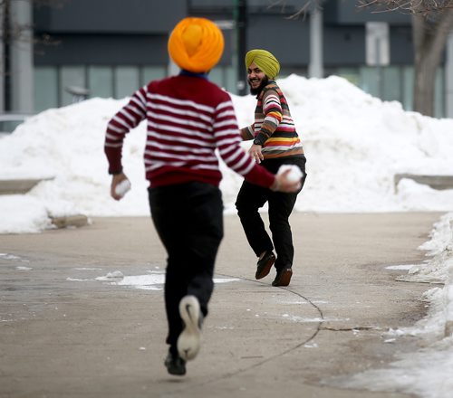 TREVOR HAGAN / WINNIPEG FREE PRESS  
Brothers Gurjeet Singh and Harshmeen Singh having a snowball fight in the warm weather by University of Winnipeg, Wednesday, March 13, 2019.