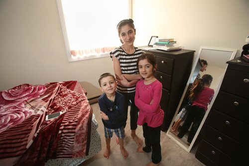 Siblings Bewar, Elham and Shewaz in one their family's sparsely furnished bedrooms. Feb.13, 2019. Shannon VanRaes/Winnipeg Free Press