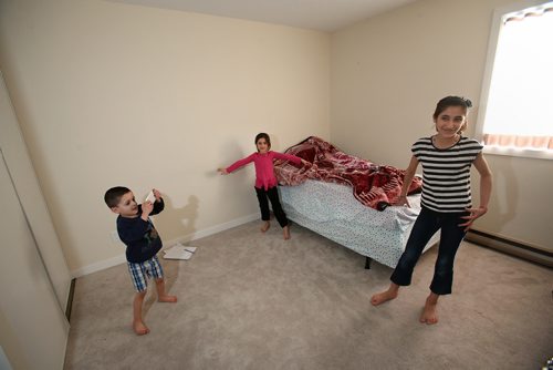 Siblings Bewar, Shewaz and Elham play in one their family's sparsely furnished bedrooms. Feb.13, 2019. Shannon VanRaes/Winnipeg Free Press