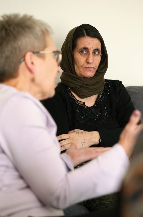 Fani Zndnam, who is expecting her tenth child after fleeing Iraq, listens as volunteer Donna Alexander explains the DNA testing that will be required to bring three of her children stranded overseas to Canada. Feb.13, 2019. Shannon VanRaes/Winnipeg Free Press