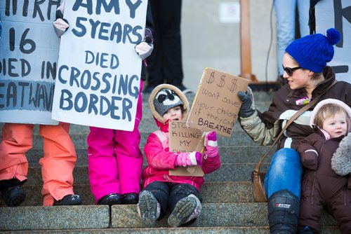 MIKAELA MACKENZIE / WINNIPEG FREE PRESS
Sophie Campbell, four, gets help with her sign from her mom, Lynn Campbell, while her little sister, Lucy Campbell, one, watches the action at a funeral for the planet at the Manitoba Legislative Building in Winnipeg on Friday, March 15, 2019. 
Winnipeg Free Press 2019.