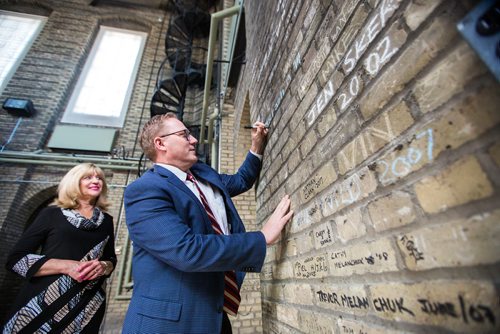 MIKAELA MACKENZIE / WINNIPEG FREE PRESS
Finance Minister Scott Fielding (right) and Sport, Culture and Heritage Minister Cathy Cox sign their names on the bricks in the area above the rotunda, in accordance with tradition, after announcing $10 million annual funding for the restoration and preservation of the Manitoba Legislative Building in Winnipeg on Friday, March 15, 2019. 
Winnipeg Free Press 2019.