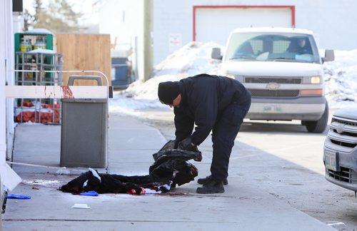 RUTH BONNEVILLE / WINNIPEG FREE PRESS

Local - A Forensic investigator picks up blood stained clothes in front of a 711 store at the Petro Canada gas station at 119 Salter Street during a homicide investigation on Saturday.   Part of Salter Street near Selkirk Ave. is closed as police officers and cadet units secure the area during the nvestigation. 


March 16,, 2019
