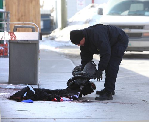 RUTH BONNEVILLE / WINNIPEG FREE PRESS

Local - A Forensic investigator picks up blood stained clothes in front of a 711 store at the Petro Canada gas station at 119 Salter Street during a homicide investigation on Saturday.   Part of Salter Street near Selkirk Ave. is closed as police officers and cadet units secure the area during the nvestigation. 


March 16,, 2019
