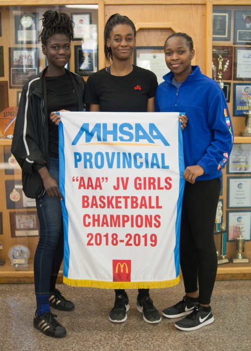 Canstar Community News March 20, 2019 - St. Norbert Collegiate's junior varsity girls basketball team was undfeated in its season, winning the AAA provincial basketball tournament on March 9. The team's captains Mercy Lasu, Fatima Ibrahim, and Hannah Olugbodi are pictured with the banner. (DANIELLE DA SILVA/SOUWESTER/CANSTAR)