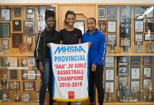 Canstar Community News March 20, 2019 - St. Norbert Collegiate's junior varsity girls basketball team was undfeated in its season, winning the AAA provincial basketball tournament on March 9. The team's captains Mercy Lasu, Fatima Ibrahim, and Hannah Olugbodi are pictured with the banner. (DANIELLE DA SILVA/SOUWESTER/CANSTAR)