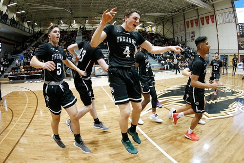 JOHN WOODS / WINNIPEG FREE PRESS
Vincent Massey Trojans' Jackson Tachinski (4) and his teammates celebrate defeating St Paul's Crusaders in the Manitoba High School 2019 AAAA Provincial Basketball Championship at the University of Manitoba Monday, March 18, 2019.