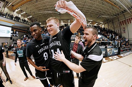 JOHN WOODS / WINNIPEG FREE PRESS
Vincent Massey Trojans' Lotachukwu Offor (9), Kyler Filewich (14) and coach Nick Lother  celebrate defeating St Paul's Crusaders in the Manitoba High School 2019 AAAA Provincial Basketball Championship at the University of Manitoba Monday, March 18, 2019.