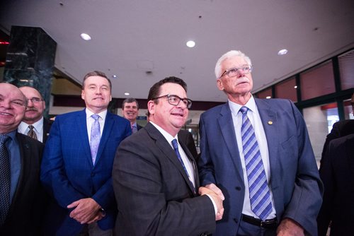 MIKAELA MACKENZIE / WINNIPEG FREE PRESS
Municipal Relations Minister Jeff Wharton (left) and Ralph Groening, president of the Association of Manitoba Municipalities, shake hands and smile after announcing an additional $10 million in unconditional operating funding to rural municipalities at the RBC Convention Centre in Winnipeg on Tuesday, March 19, 2019. 
Winnipeg Free Press 2019.