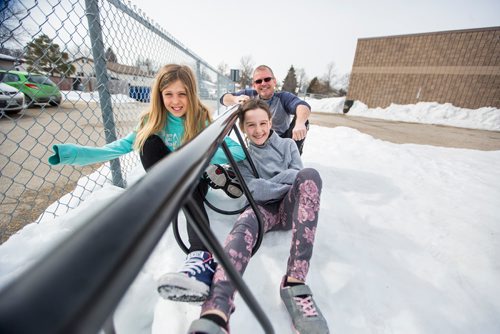 MIKAELA MACKENZIE / WINNIPEG FREE PRESS
Teacher Luc Roy and students Emily (left) and Isabella pose for a photo at Ecole Sun Valley School with a bike rack they received free of charge last year from the Green Action Centre in Winnipeg on Tuesday, March 19, 2019. 
Winnipeg Free Press 2019.