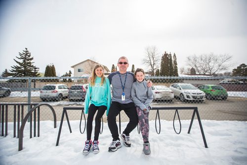 MIKAELA MACKENZIE / WINNIPEG FREE PRESS
Teacher Luc Roy and students Emily (left) and Isabella pose for a photo at Ecole Sun Valley School with a bike rack they received free of charge last year from the Green Action Centre in Winnipeg on Tuesday, March 19, 2019. 
Winnipeg Free Press 2019.