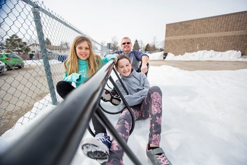 MIKAELA MACKENZIE / WINNIPEG FREE PRESS
Teacher Luc Roy and students Emily (left) and Isabella pose for a photo at Ecole Sun Valley School with a bike rack they received free of charge last year from the Green Action Centre in Winnipeg on Tuesday, March 19, 2019. 
Winnipeg Free Press 2019.