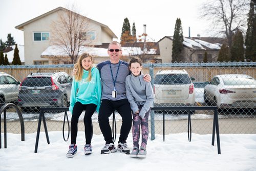 MIKAELA MACKENZIE / WINNIPEG FREE PRESS
Teacher Luc Roy and students Emily (left) and Isabella pose for a photo at Ecole Sun Valley School with a bike rack they received free of charge last year from the Green Action Centre in Winnipeg on Tuesday, March 19, 2019. 
Winnipeg Free Press 2019.