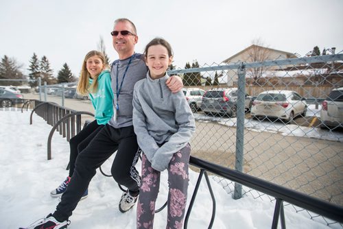 MIKAELA MACKENZIE / WINNIPEG FREE PRESS
Teacher Luc Roy and students Emily (left) and Isabella pose for a photo at Ecole Sun Valley School with a bike rack they received free of charge last year from the Green Action Centre in Winnipeg on Tuesday, March 19, 2019. 
Winnipeg Free Press 2019.