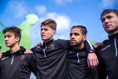 MIKAELA MACKENZIE / WINNIPEG FREE PRESS
Valour FC players Raphael Garcia (left), Tyler Attardo, Federico Pena, and Calum Ferguson huddle while visiting the Valour Road Commemorative Plaza to learn about the inspiration and naming of Valour FC in Winnipeg on Wednesday, March 20, 2019. 
Winnipeg Free Press 2019.