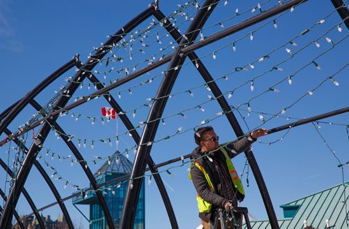 MIKE DEAL / WINNIPEG FREE PRESS
A sure sign that spring has arrived, the taking down of Christmas lights at The Forks has started.
Adrian Miller with Lights Unlimited removes the holiday lights along the Tunnel of Light at The Forks Wednesday afternoon. 
190320 - Wednesday, March 20, 2019.