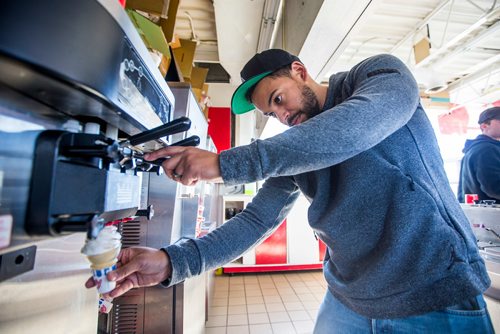 MIKAELA MACKENZIE / WINNIPEG FREE PRESS
Owner Justin Jacob makes the very first cone of the season for some extra cute kids before the official opening time at Bridge Drive In on opening day in Winnipeg on Friday, March 22, 2019.
Winnipeg Free Press 2019.