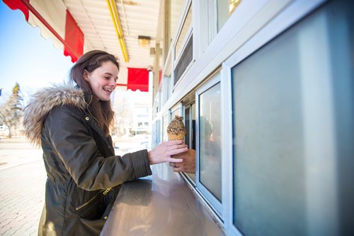 MIKAELA MACKENZIE / WINNIPEG FREE PRESS
Ellen Johnson gets a Cookie Monster ice cream on opening day at Bridge Drive In in Winnipeg on Friday, March 22, 2019. 
Winnipeg Free Press 2019.
