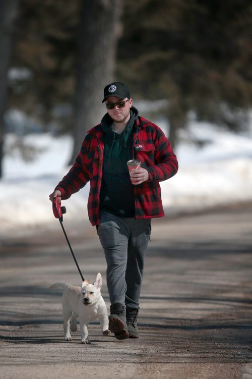 PHIL HOSSACK / WINNIPEG FREE PRESS - STANDUP 10 week old yellow lab 'Gunner' introduces his owner James Armstrong to the fine art of walking on a leash Saturday afternoon. The pair were walking the rounds at St Vital Park enjoying the forecasted +8C temps. ONE of TWO pics -  March 23, 2019.
