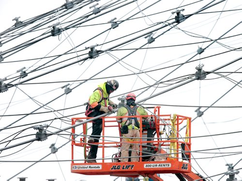 PHIL HOSSACK / WINNIPEG FREE PRESS - STAND-UP A pair of construction workers lace up suspension wires making up part of the Canada's Diversity Gardens structure rising in Assiniboine Park Tuesday afternoon. STAND-UP - March 26, 2019.