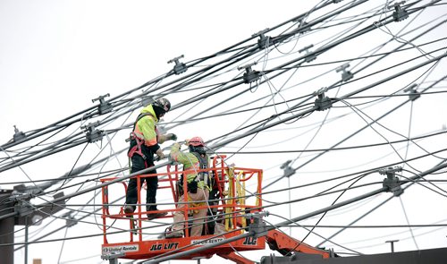PHIL HOSSACK / WINNIPEG FREE PRESS - STAND-UP A pair of construction workers lace up suspension wires making up part of the Canada's Diversity Gardens structure rising in Assiniboine Park Tuesday afternoon. STAND-UP - March 26, 2019.