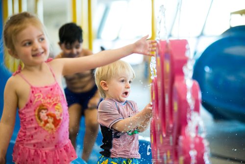 MIKAELA MACKENZIE / WINNIPEG FREE PRESS
Torren Low, two (centre) and his older sister, Aidrie Low, play at the citys first indoor splash pad at Seven Oaks Pool in Winnipeg on Thursday, March 28, 2019. 
Winnipeg Free Press 2019.